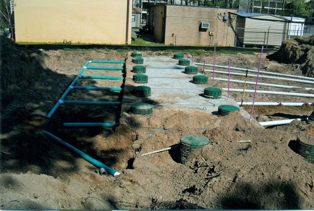 A construction site with a yellow building in the background