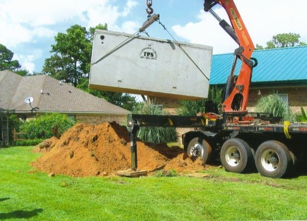 A crane is lifting a container that says jpn on it