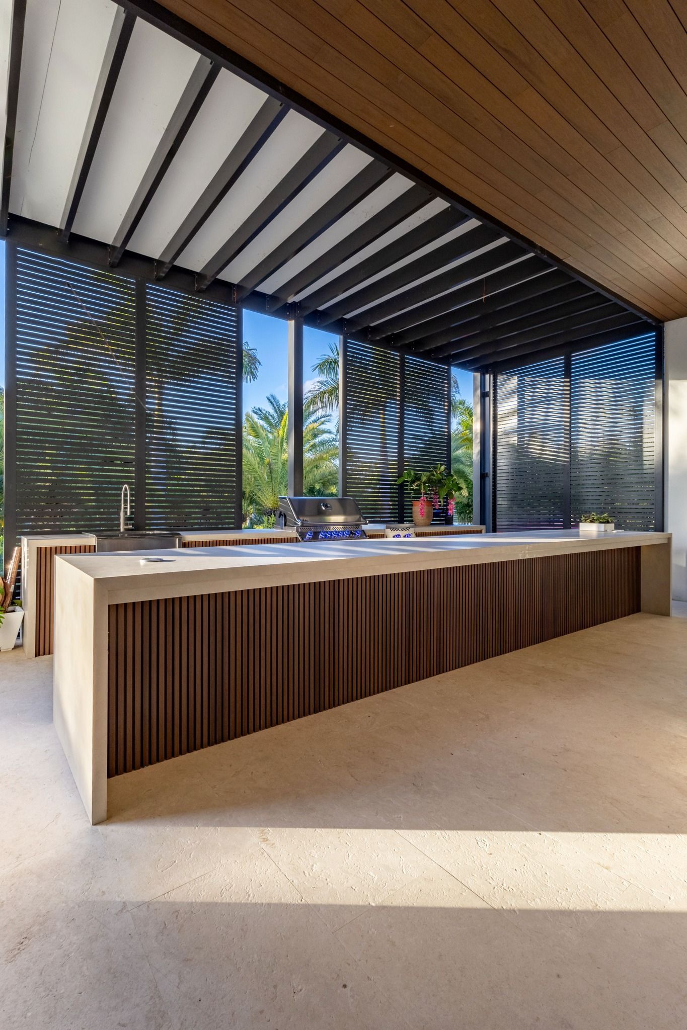 A kitchen with a large island and a large window