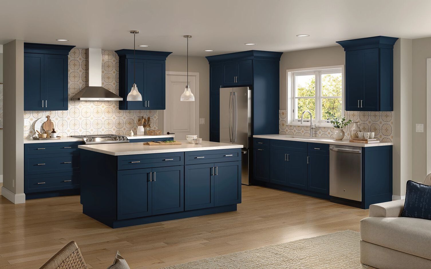 Navy blue kitchen with island, cabinets, and stainless steel appliances. Beige countertops and backsplash.