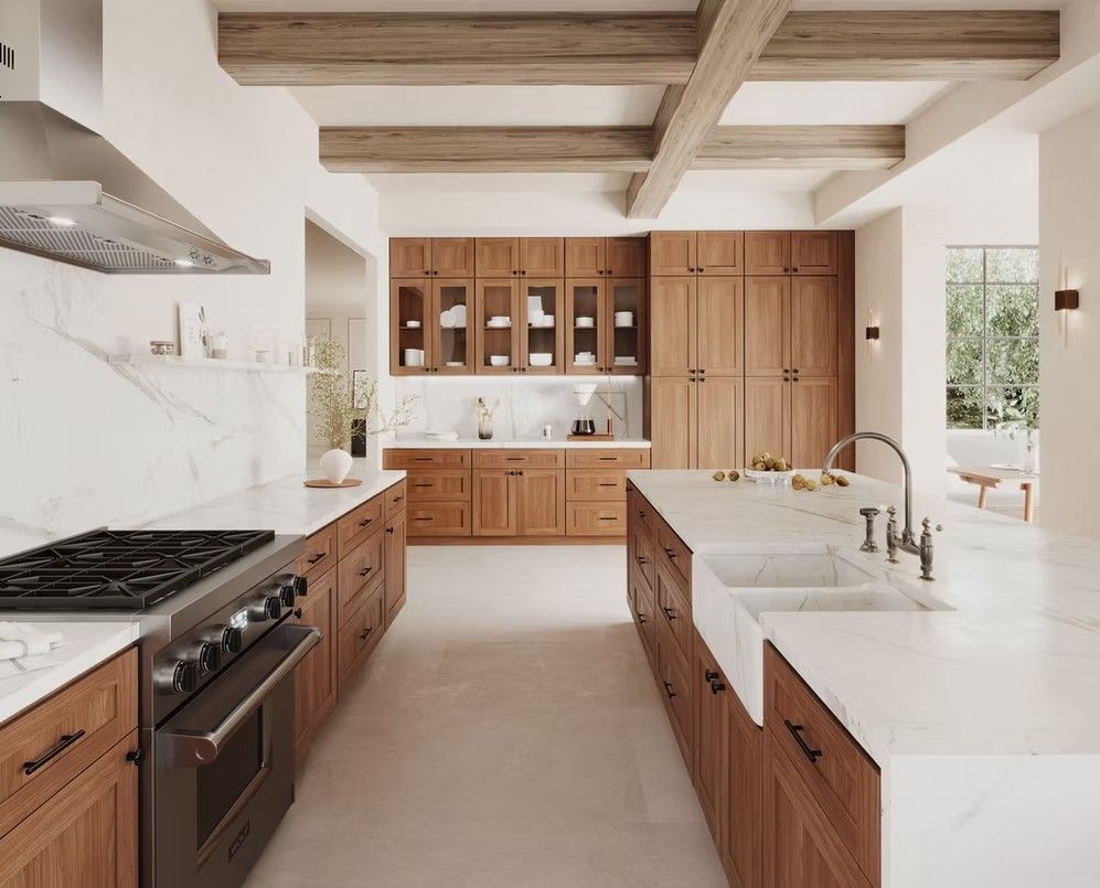 Spacious kitchen with wood cabinets, marble countertops, stainless steel appliances, and a large island.