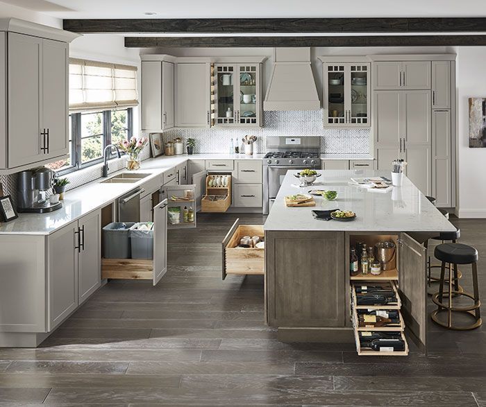 Modern kitchen with gray cabinets, island, and pull-out drawers for storage.