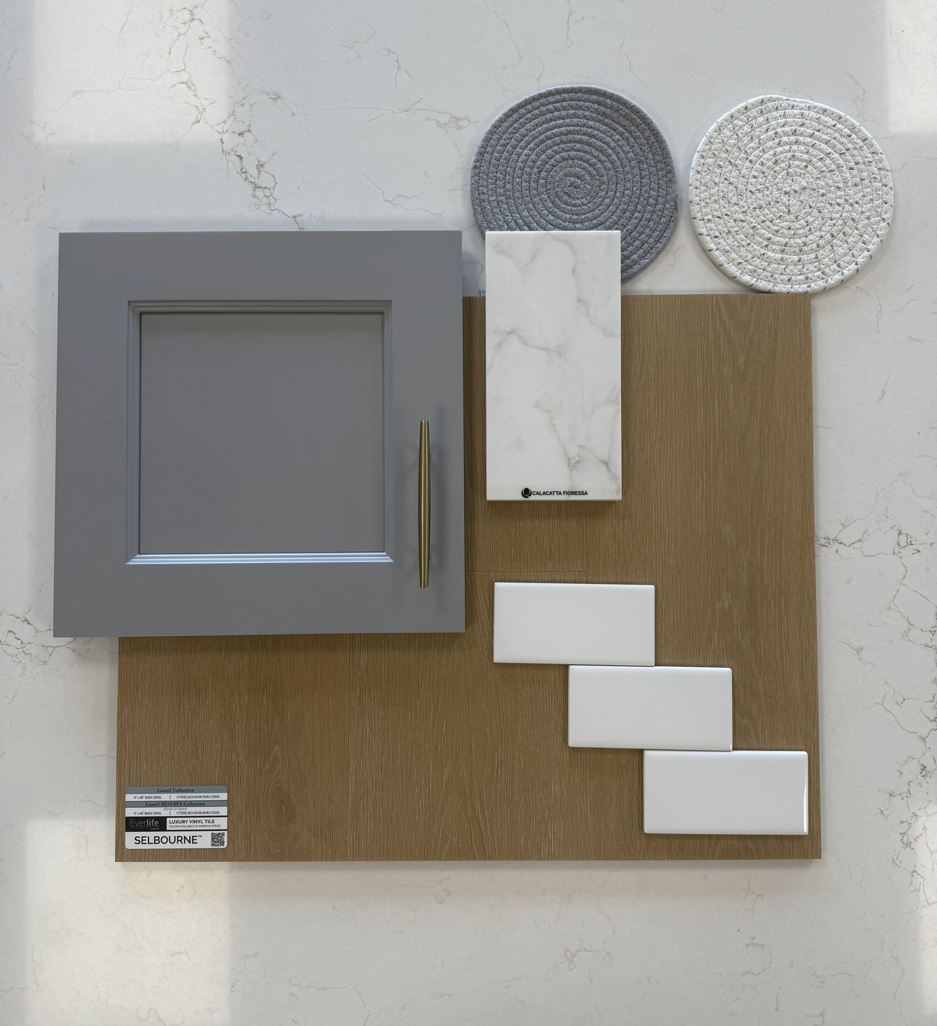 A design mood board features a grey cabinet door, light oak wood, white marble, matte white tiles, and circular textures.
