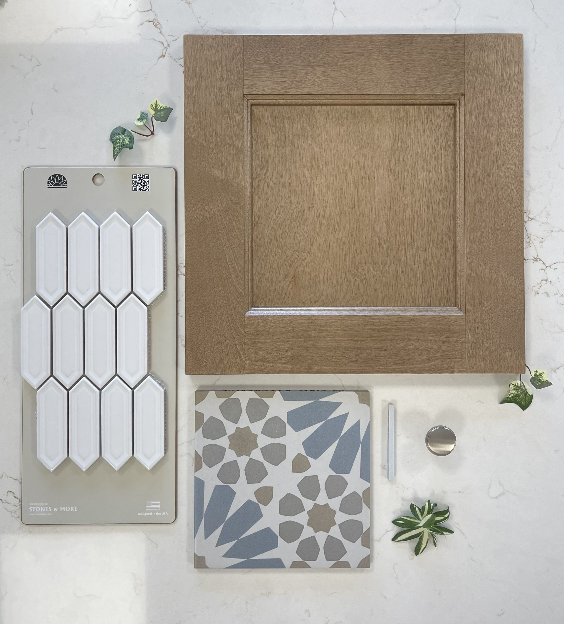 A design mood board with a wooden cabinet door, white elongated tiles, a patterned geometric tile, and a metal knob.
