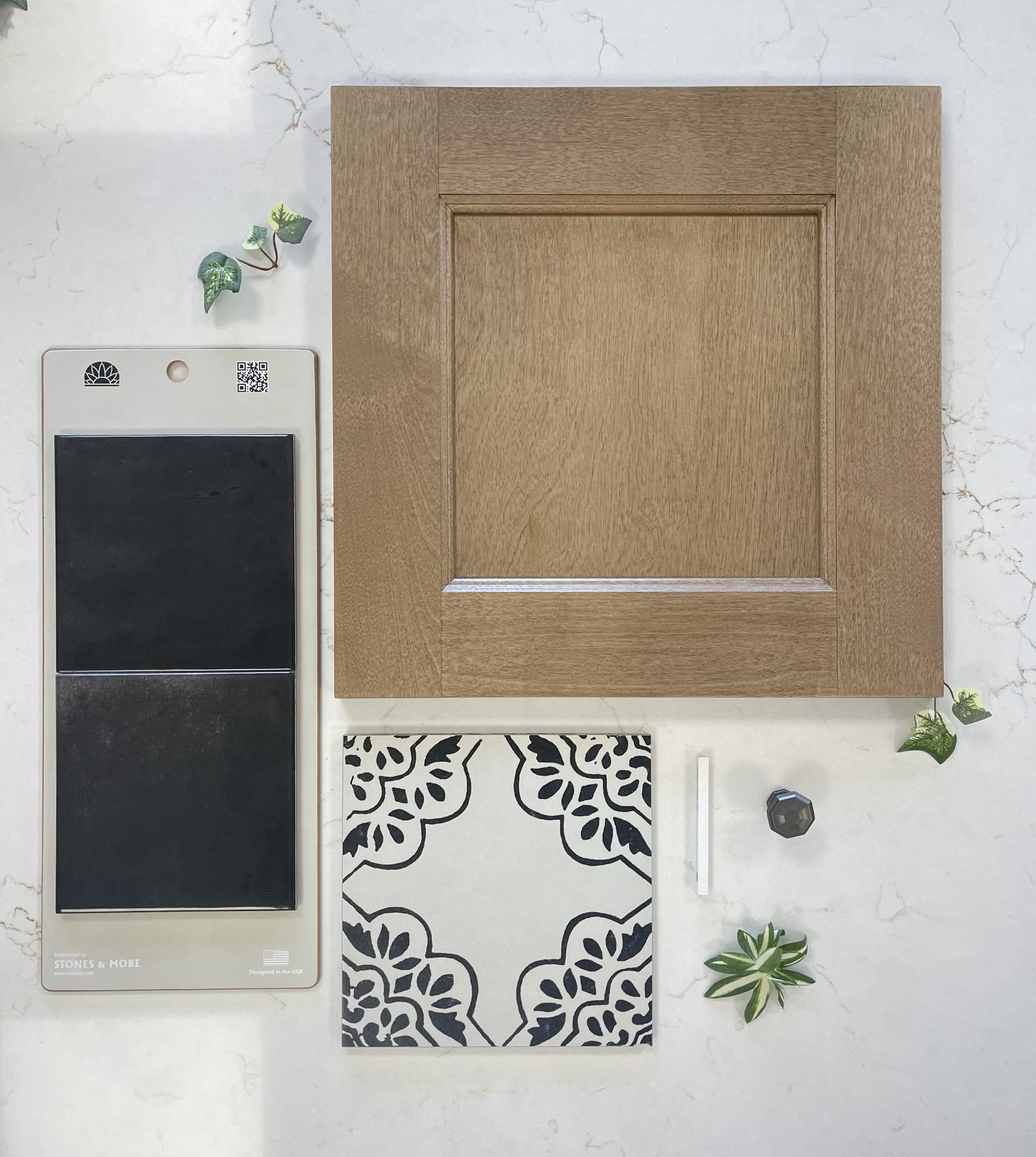 Design samples showing a square wood cabinet door, a patterned black and white tile, fabric swatches, and small hardware.
