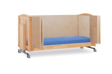 Child's bed with beige walls, blue mattress, and wheels.
