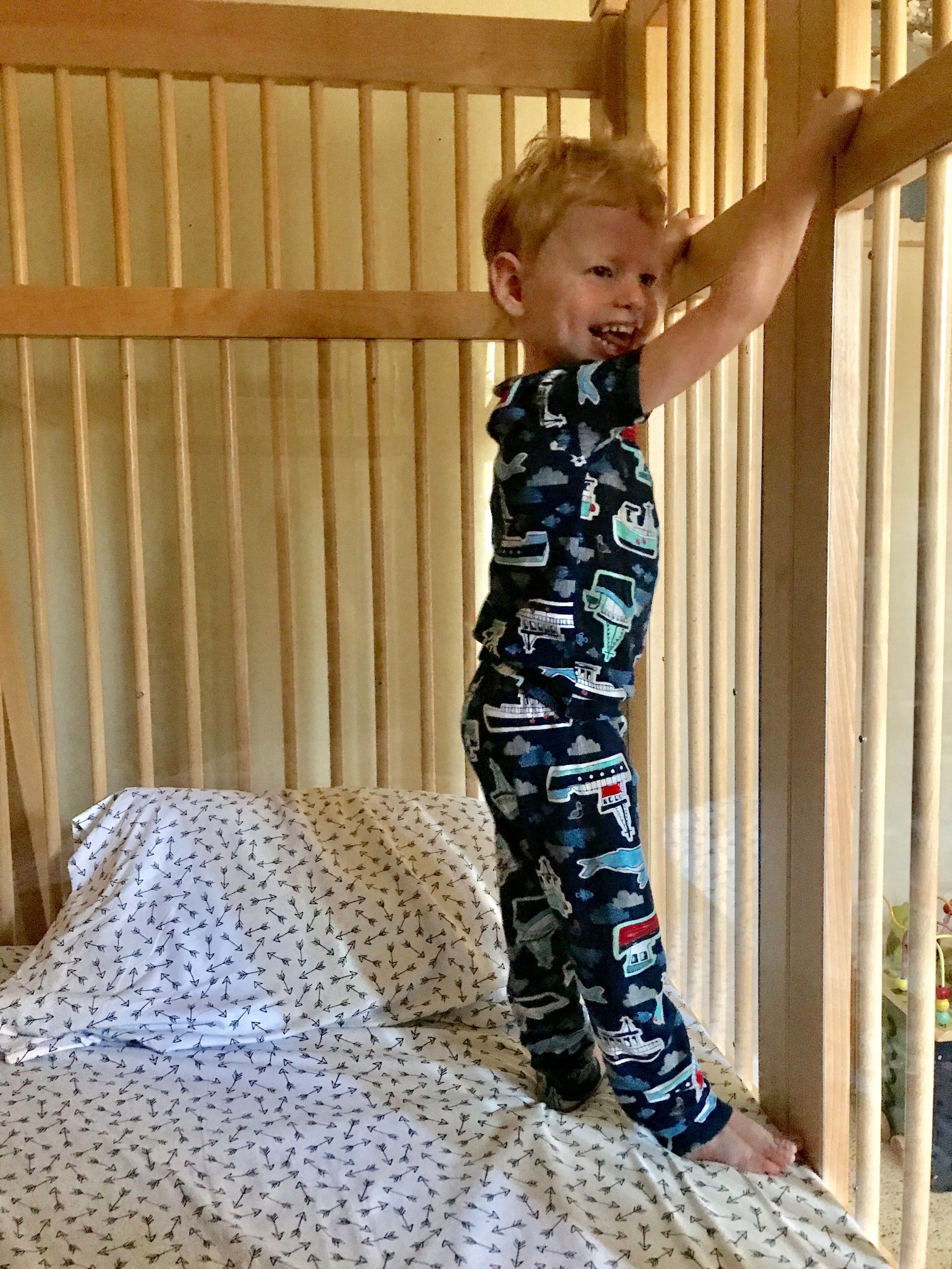 Boy inside a wooden crib