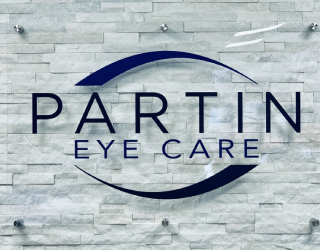Partin Eye Care logo on a light stone background with dark blue text and oval graphic