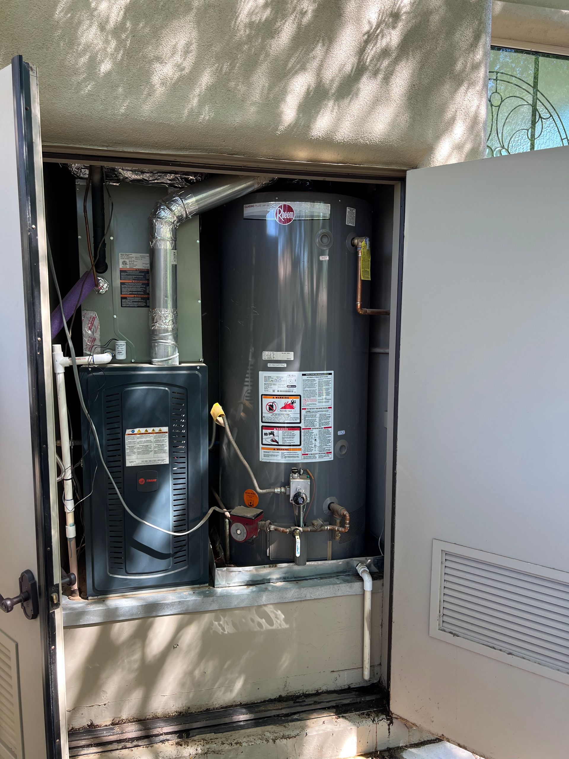 Water heater and furnace inside a utility closet.