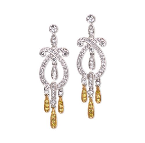 A pair of earrings with yellow and white stones