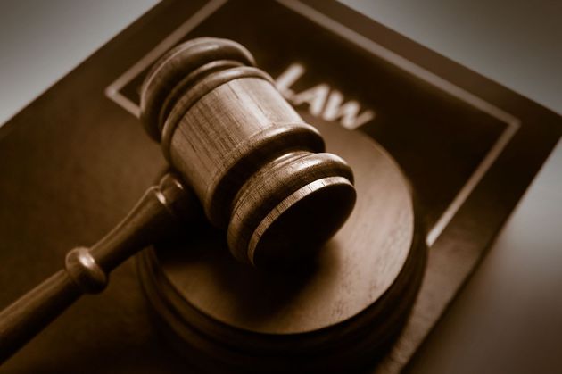 Judge’s gavel resting on a law book, symbolizing the legal system.