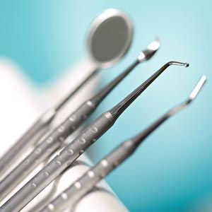 A close up of dental instruments on a blue background