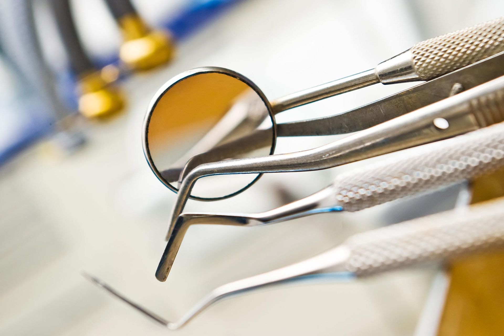 A close up of dental instruments including a mirror and tweezers
