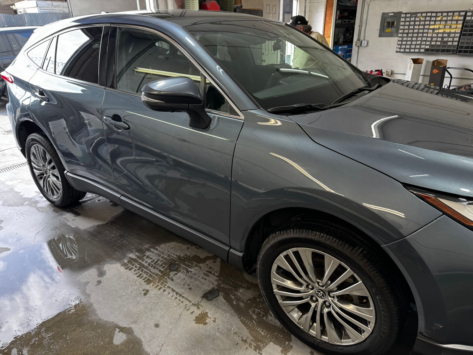 Gray Toyota Venza SUV parked indoors; shiny, clean exterior.