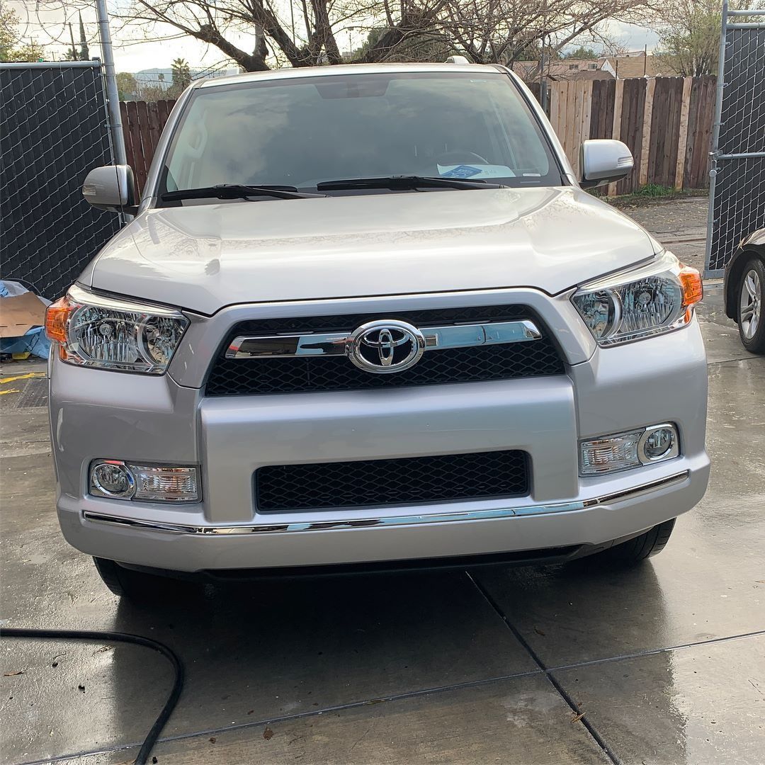 Silver Toyota 4Runner SUV parked on a paved surface, facing forward.