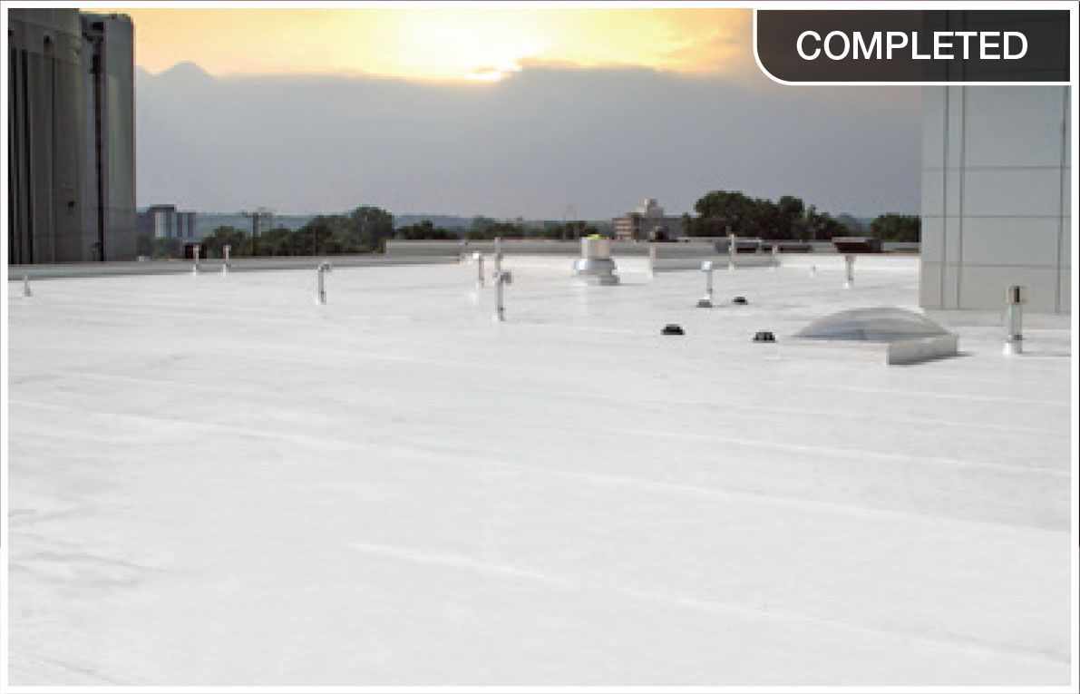 White rooftop with HVAC units at sunset, labeled “COMPLETED” in the top right.