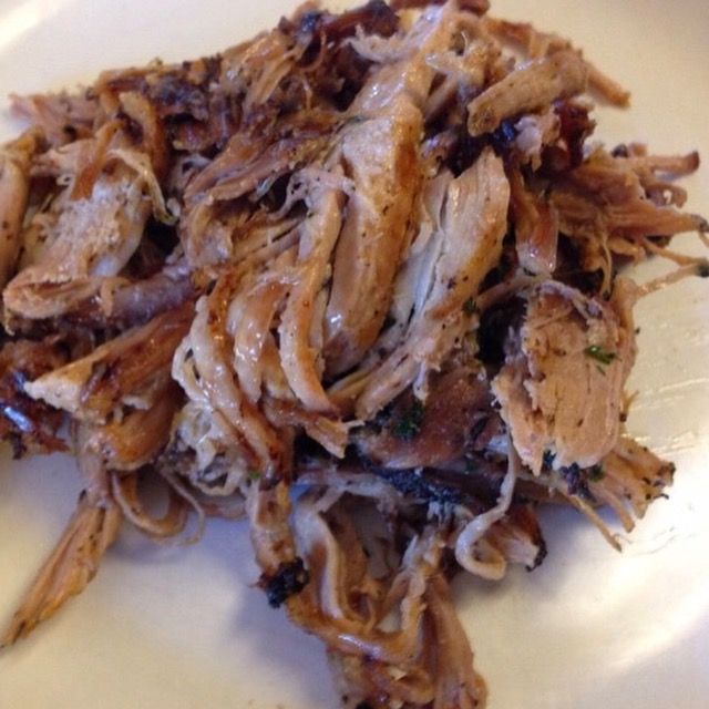 Shredded, cooked pork on a white plate