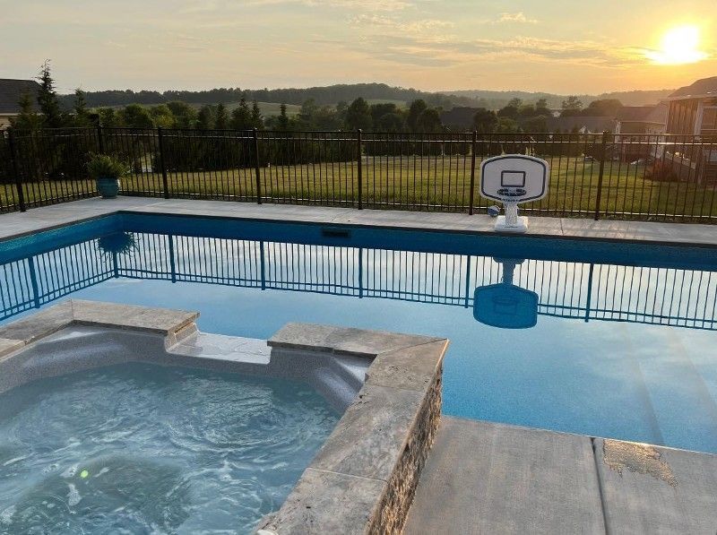 There is a basketball hoop in the middle of the pool.