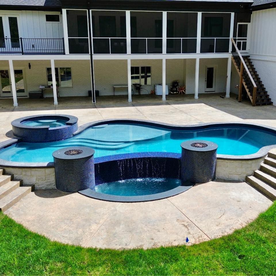 A large swimming pool in front of a house
