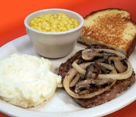 Meat with toast and corn on plate