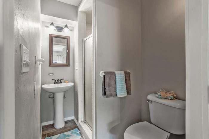 A bathroom with a sink , toilet and shower.