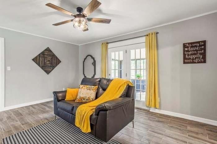 A living room with a couch and a ceiling fan