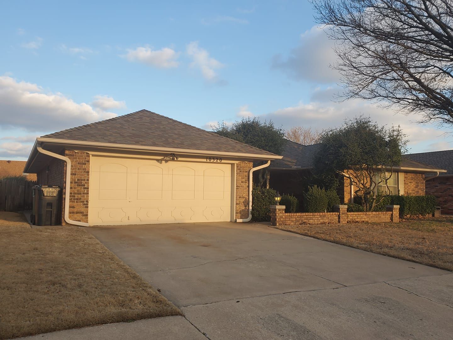 A house with a garage and a driveway in front of it
