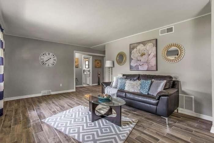 A living room with a couch , coffee table , and rug.