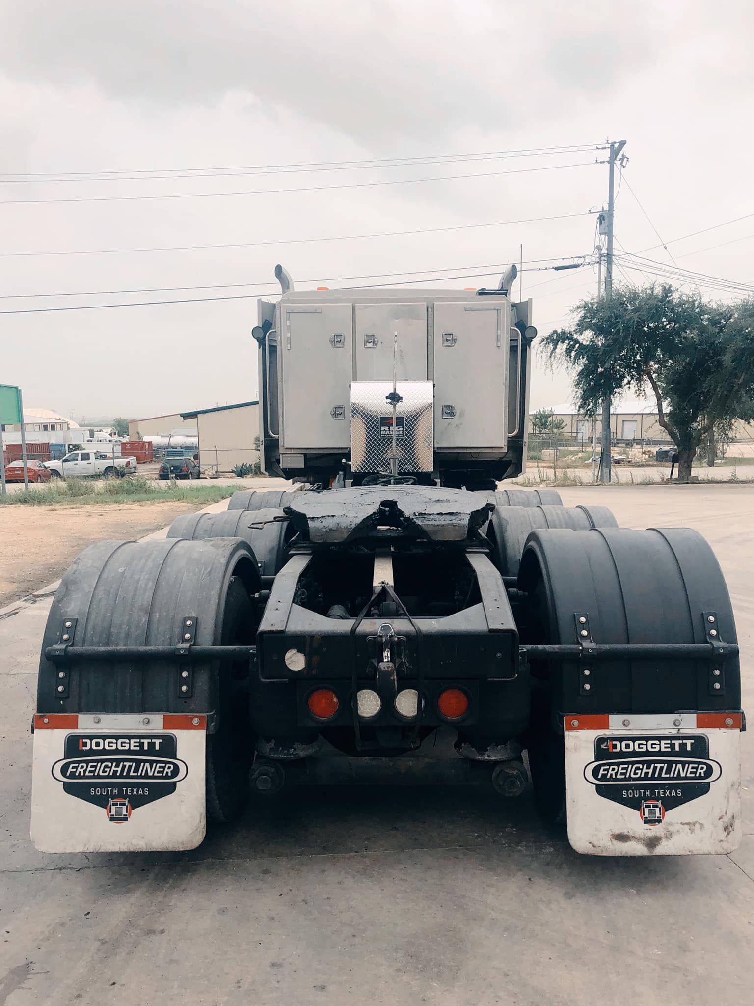 a semi-truck is parked on the side of the road.