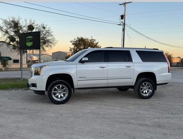 A white SUV is parked on the side of the road.