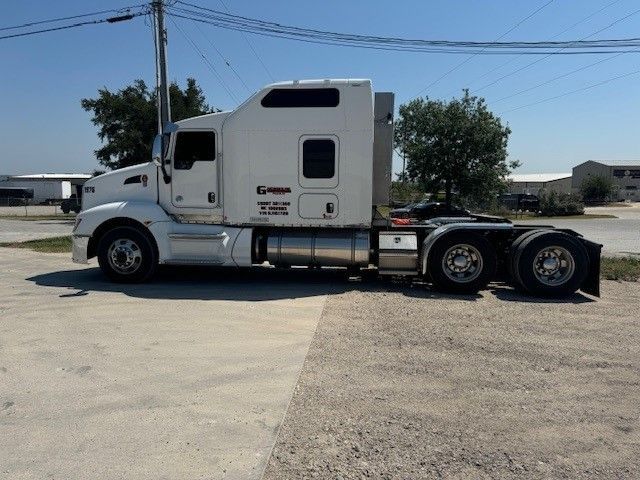 A white semi truck is parked on the side of the road
