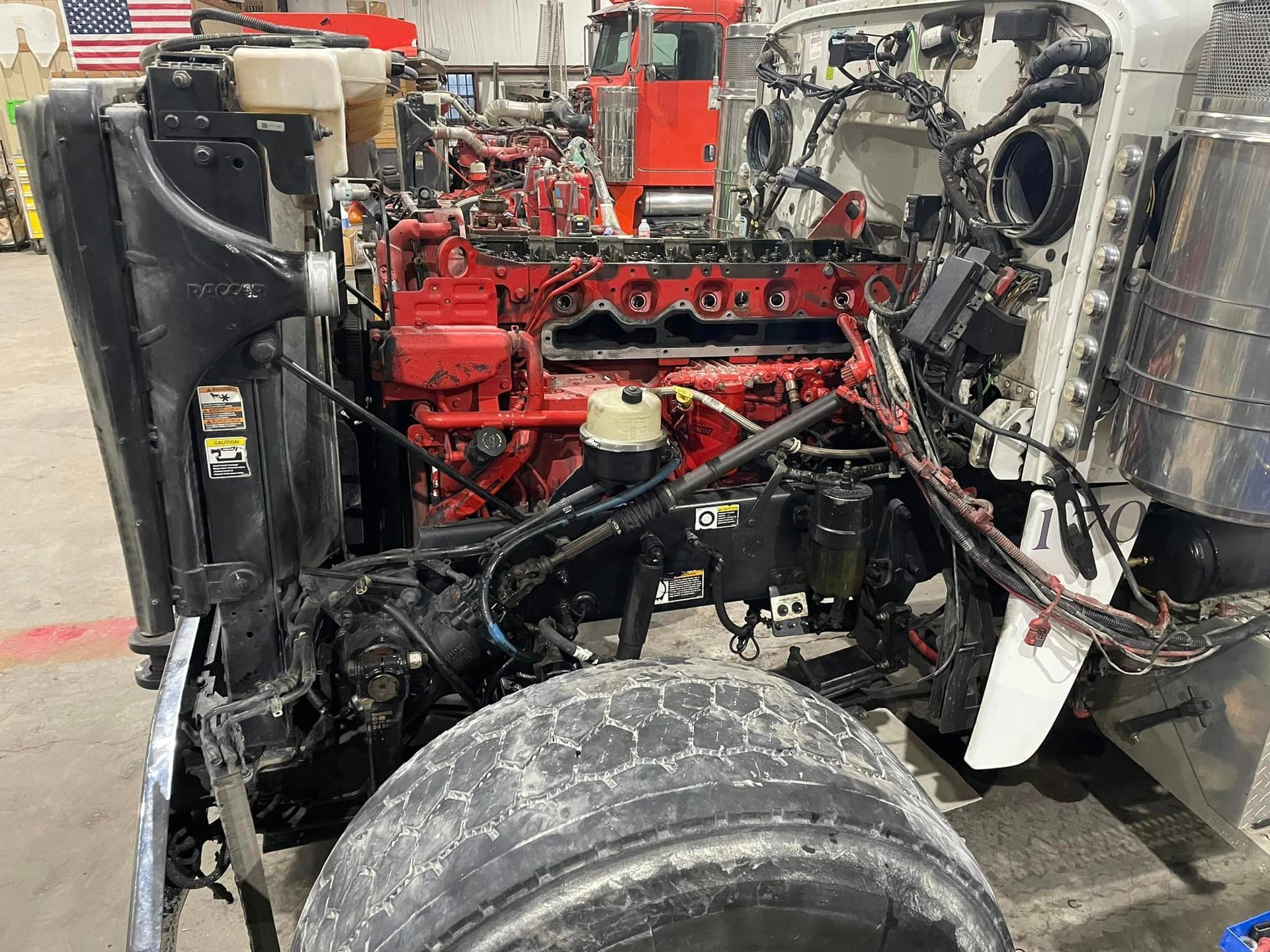 a truck with the engine removed is sitting in a garage .