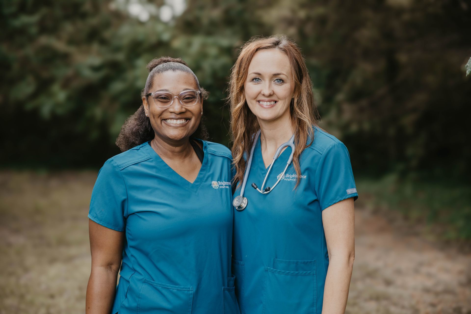 two nurses are posing for a picture