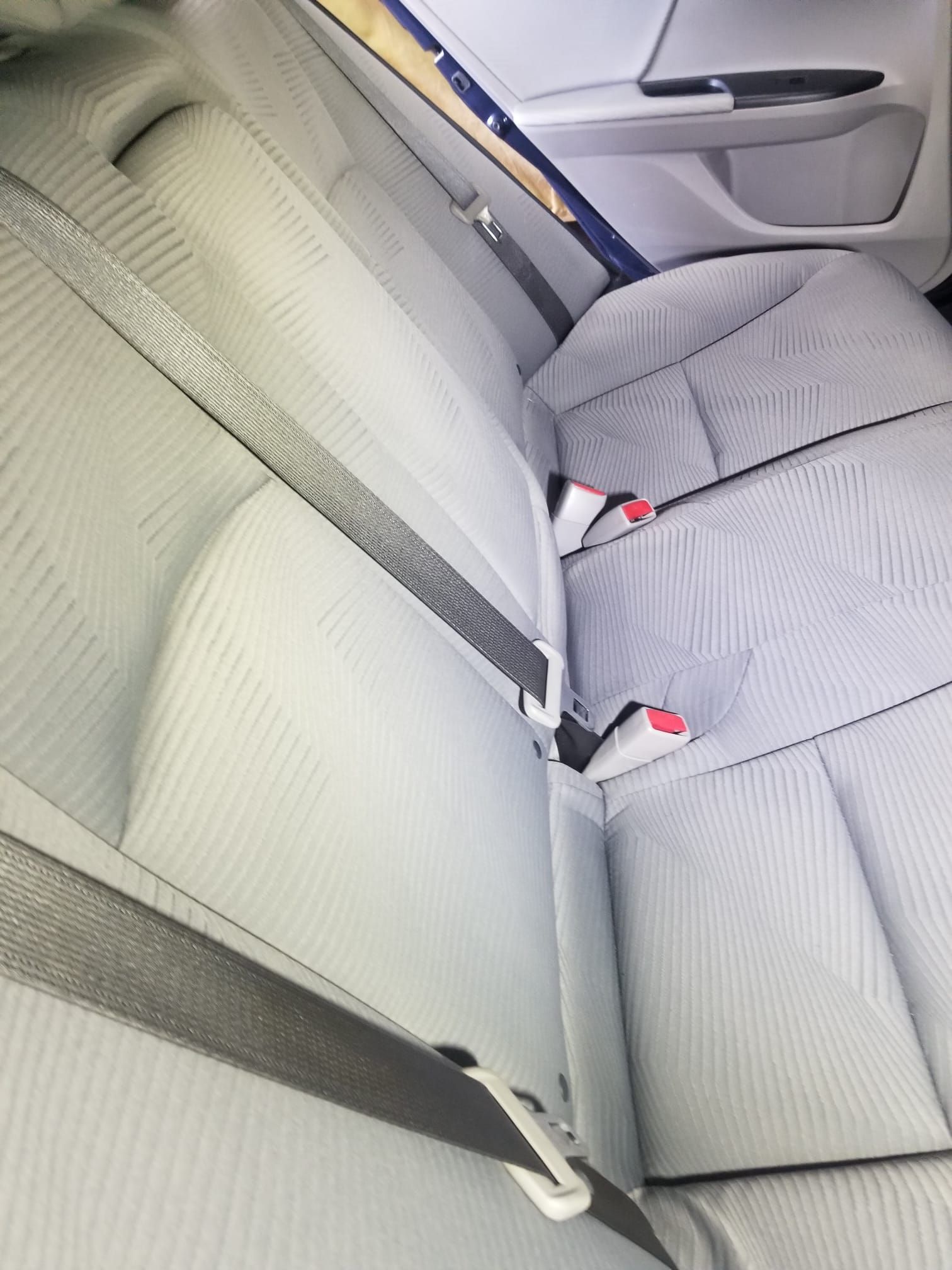 A close up of a car seat with a seat belt