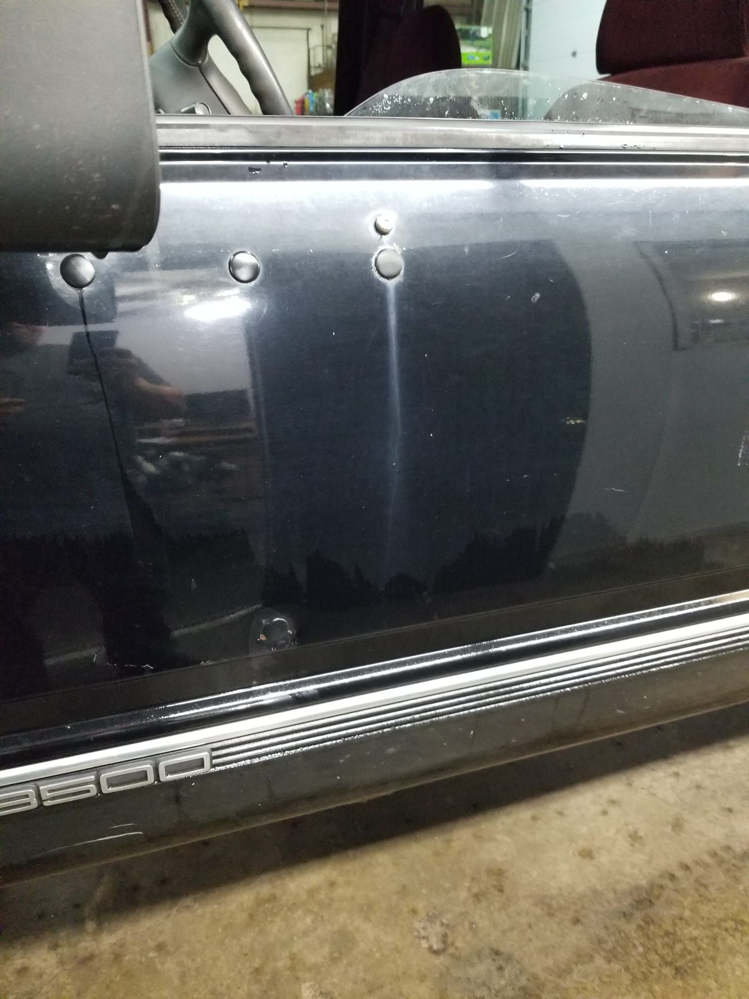 Black car door with holes