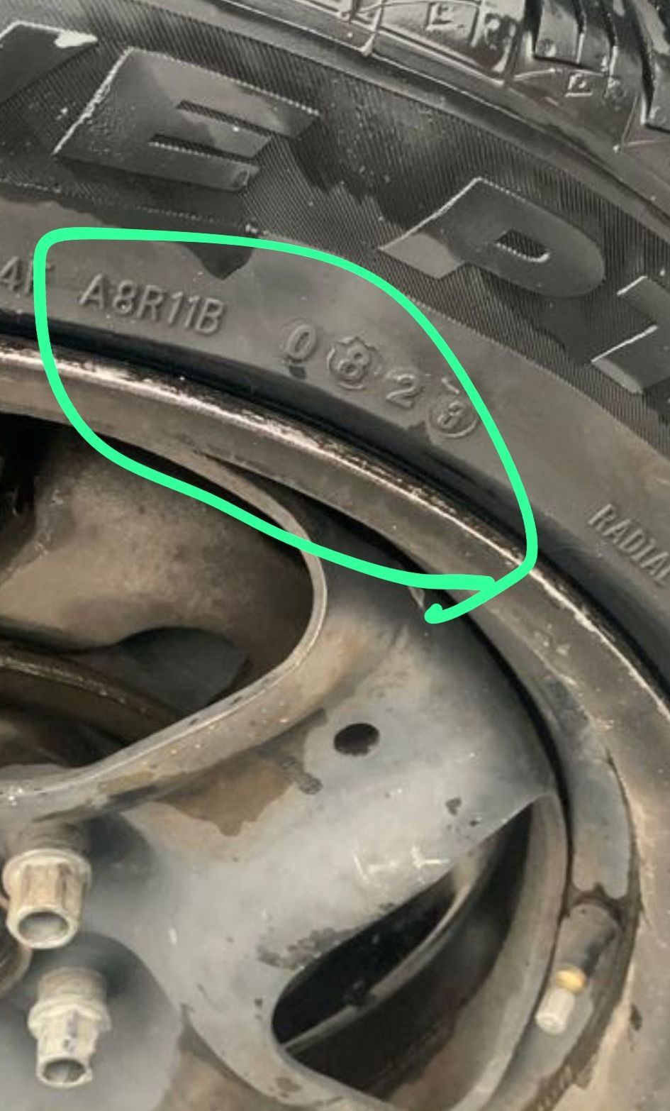 A close up of a tire with a green circle around it.