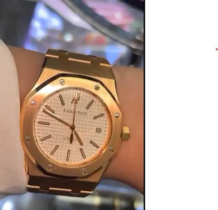 Rose gold wristwatch with a round face and Roman numerals on a wrist
