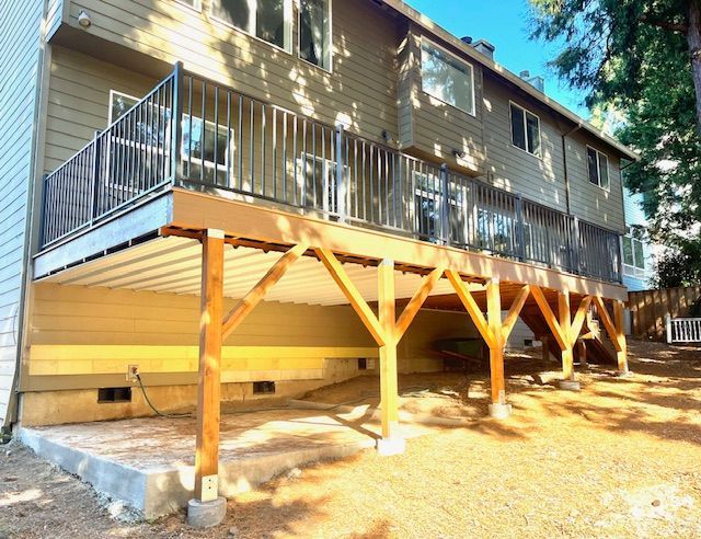 A large deck is being built on the side of a house.