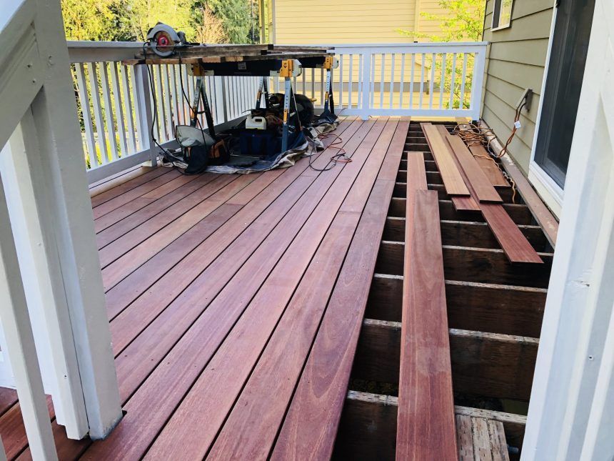 A wooden deck is being built on the side of a house
