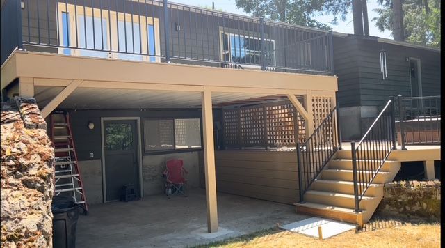 A house with a large deck and stairs leading up to it.