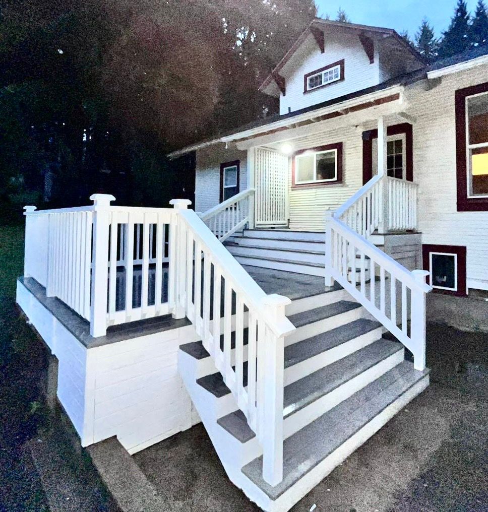 A white house with stairs leading up to it