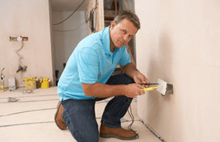 Man installing electric outlet