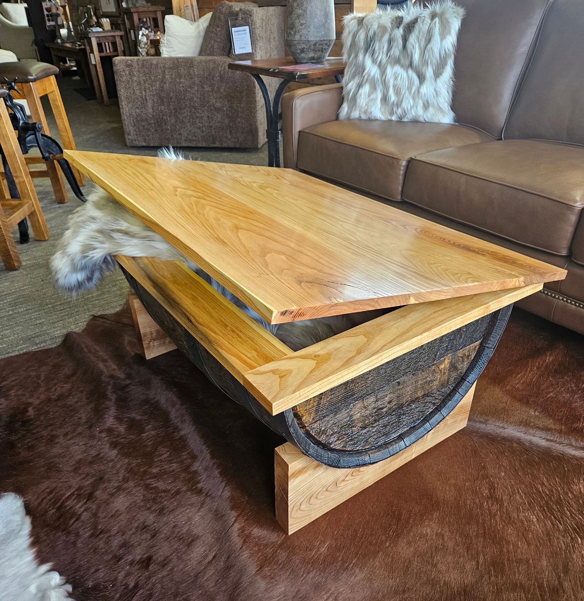 A wooden coffee table is sitting in a living room next to a couch.