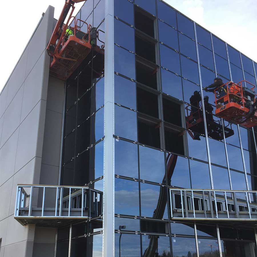 A building with a lot of windows is being worked on