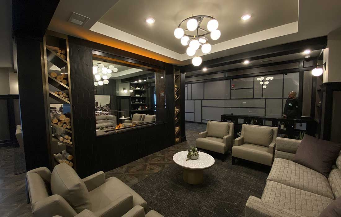 A living room with a couch , chairs and a table