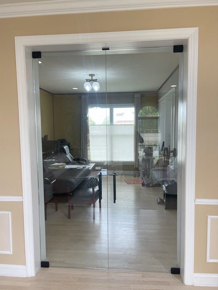 A living room with sliding glass doors leading to a dining room.