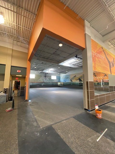 An empty gym with a sign that says ' ultimate ' on it