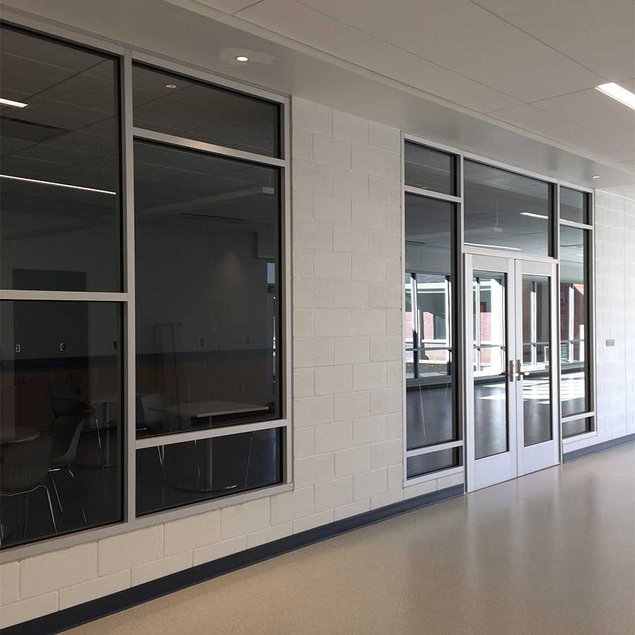 A hallway with a lot of windows and doors