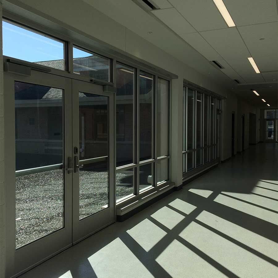 A hallway with a lot of windows and doors