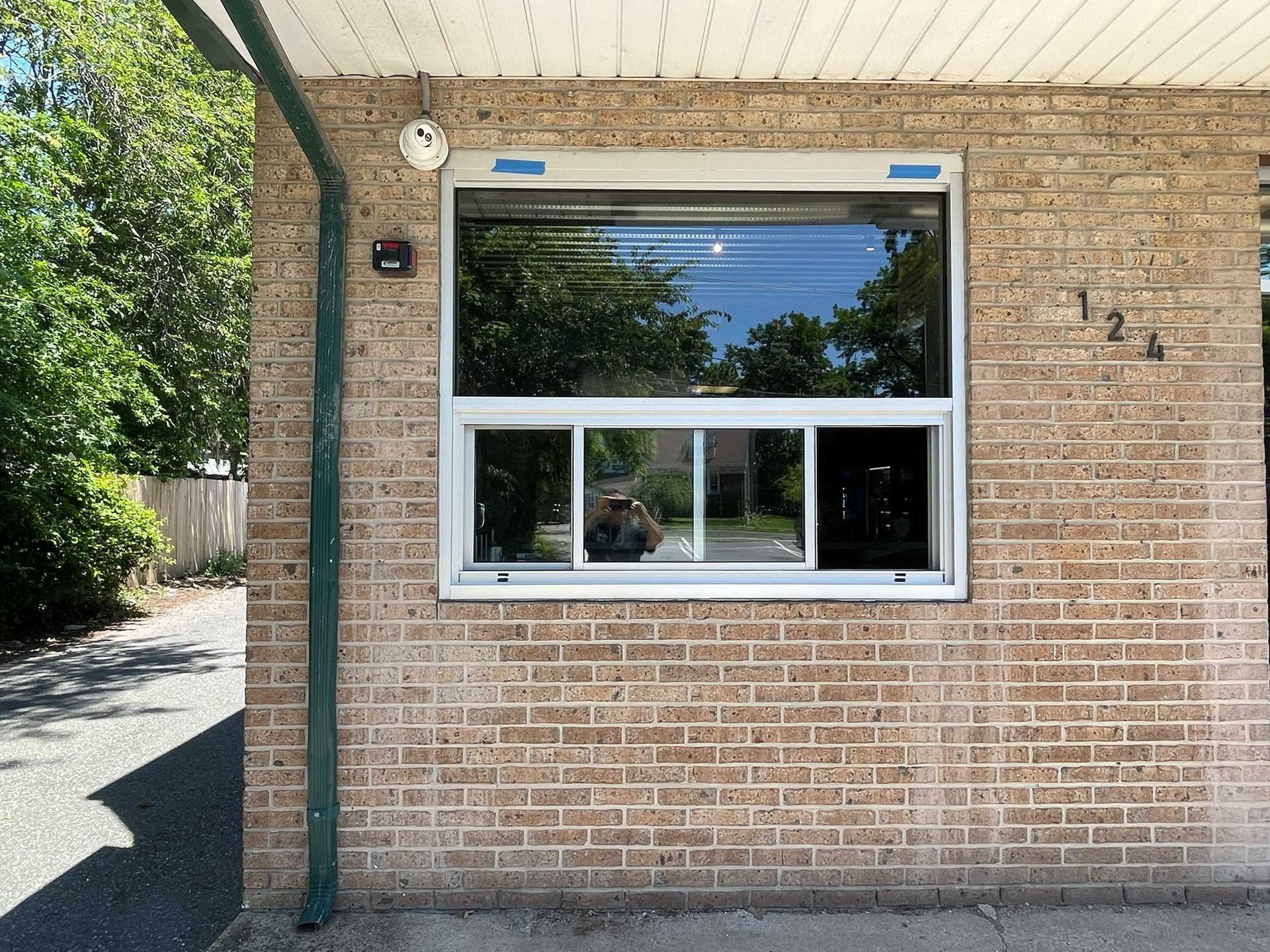 A brick building with a window and the number 12 on it
